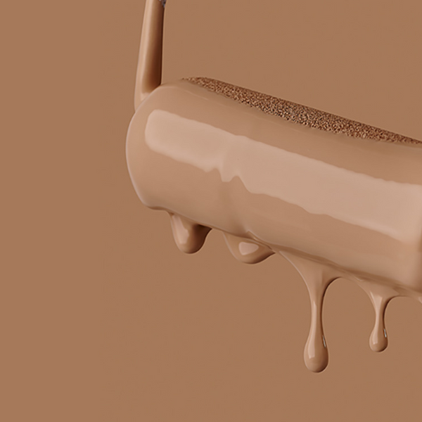 close-up of a paint-drenched paint roller with paint drips coming down from it in a warm brown colour photographed on a warm brown background